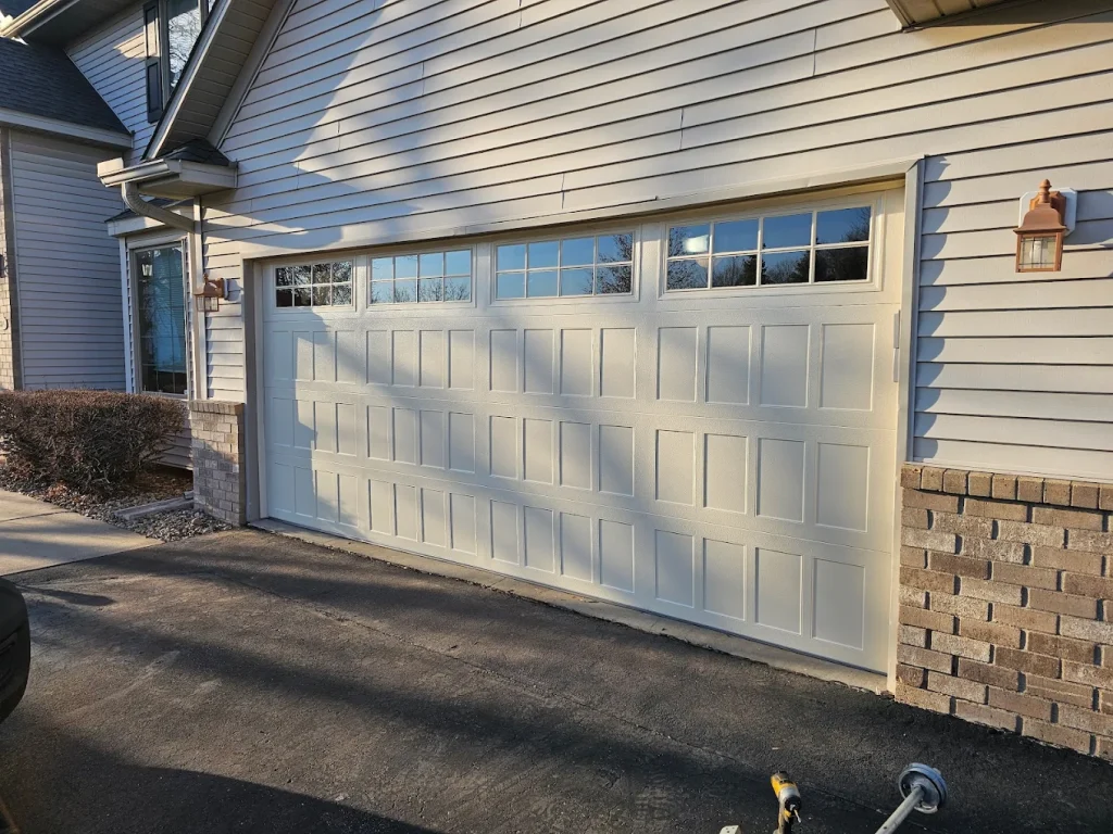 Completed white garage door with glass windows installation Minnesota