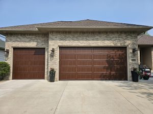 Stunning double wood grain garage door installation on brick home in Minneapolis Saint Paul Minnesota by David's Urgent Garage Door
