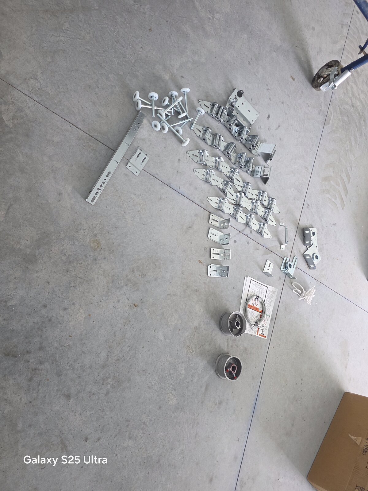 New garage door hardware laid out before installation