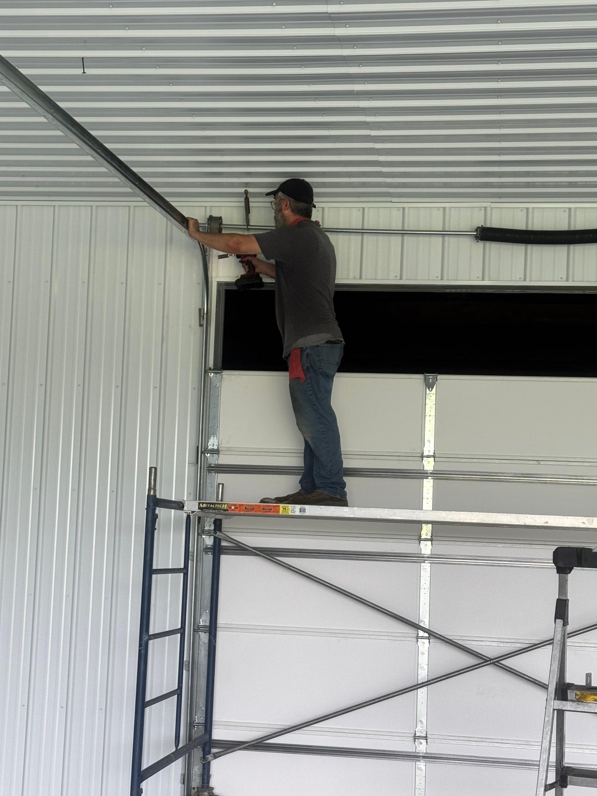 Securing a garage door track during a new install