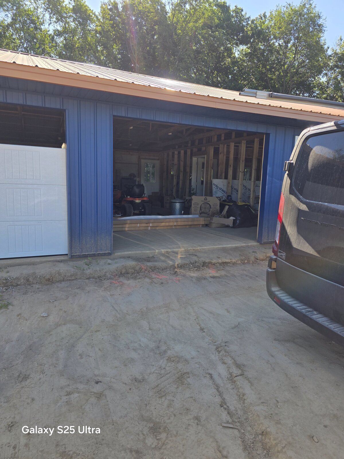 New pole barn garage door installation in progress