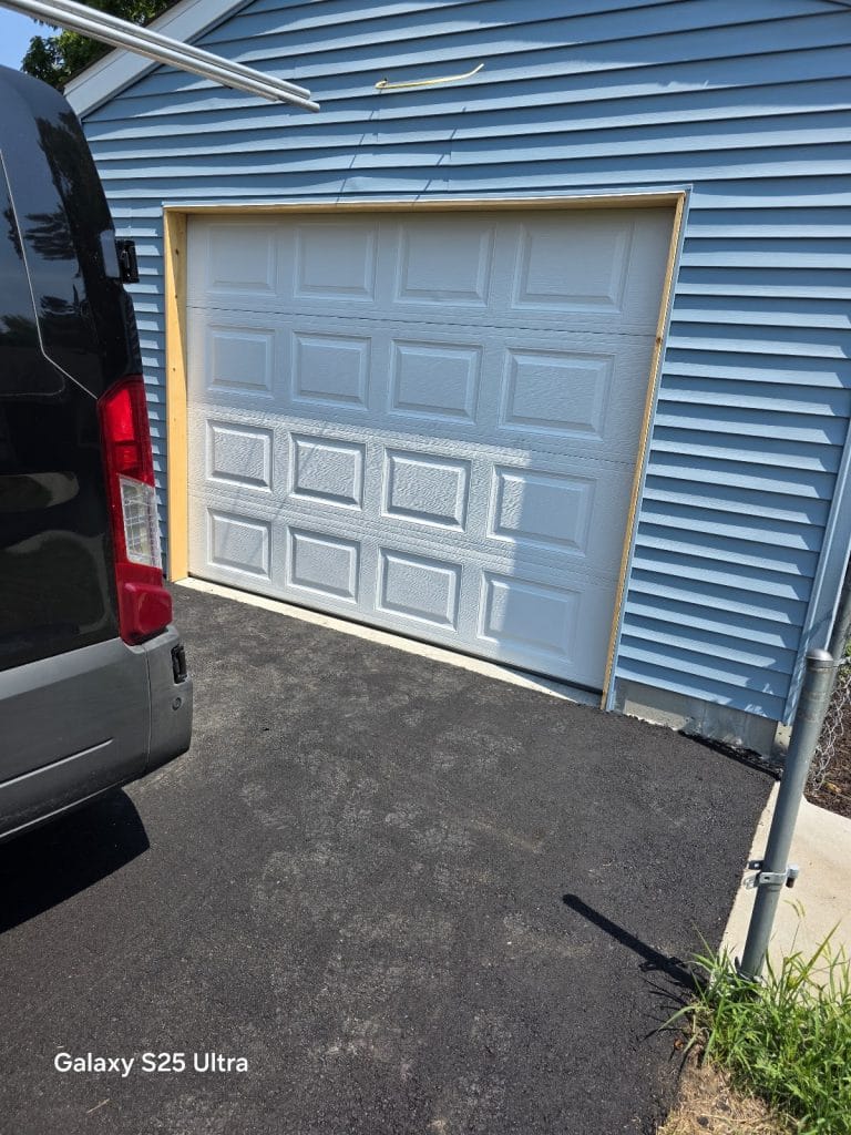 Blue garage door with the service van in the driveway, Minnesota
