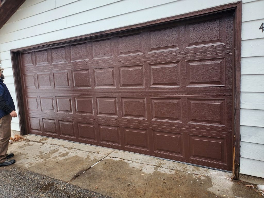 New brown double garage door, exterior view after installation