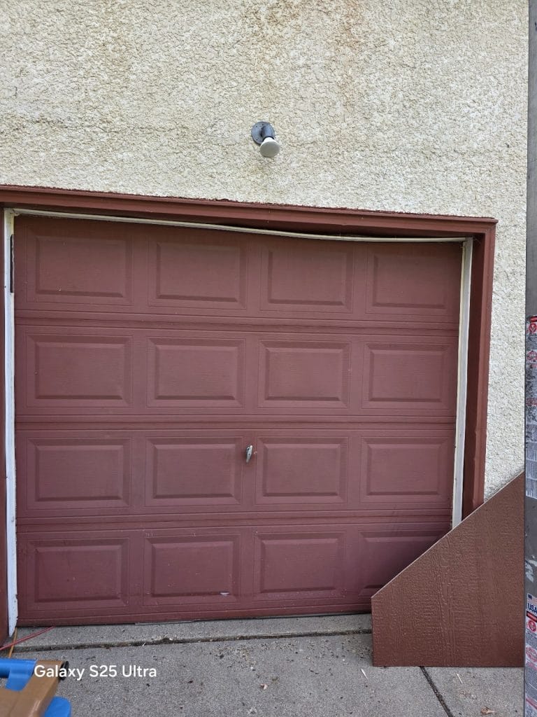 Brown garage door installed on an alley garage, Minneapolis area