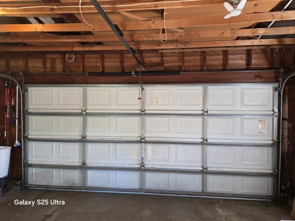 New DoorLink 3640 white insulated garage door installed, view from inside the garage