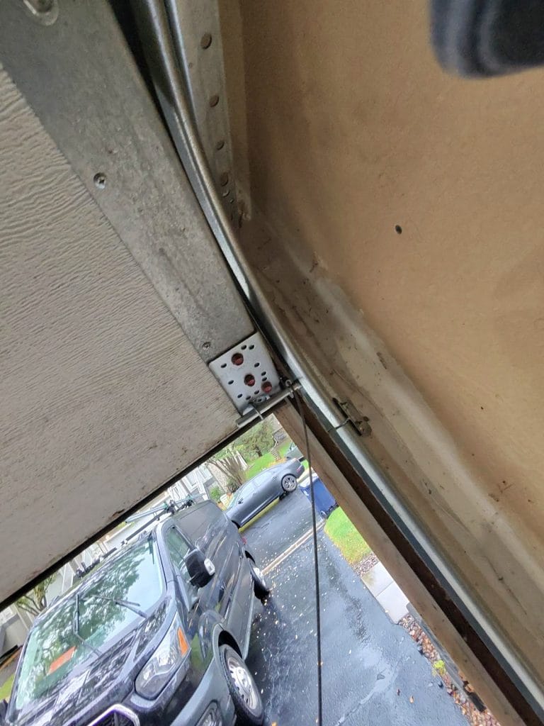 Loose garage door cable that came off the drum, leaving the door crooked