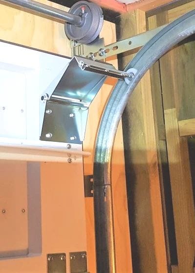 Garage door track radius curve and flag bracket where the vertical track meets the horizontal track