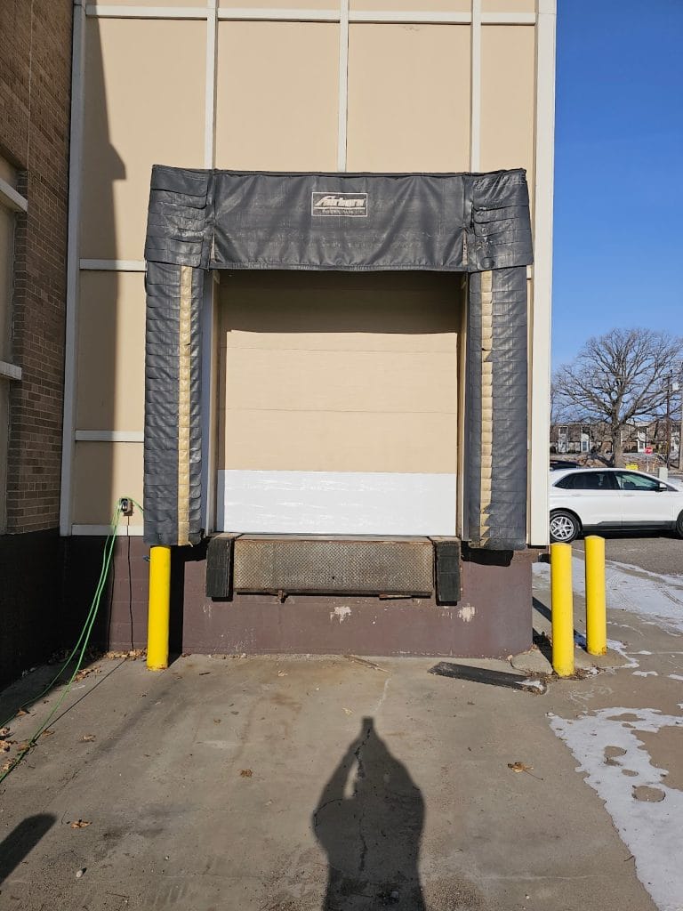 Loading dock door with dock seal and bumpers after commercial garage door repair in Minnesota