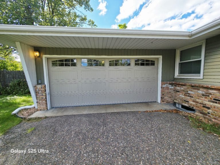 New DoorLink garage door with a window top section after replacing an old dented raised-panel door, Twin Cities MN
