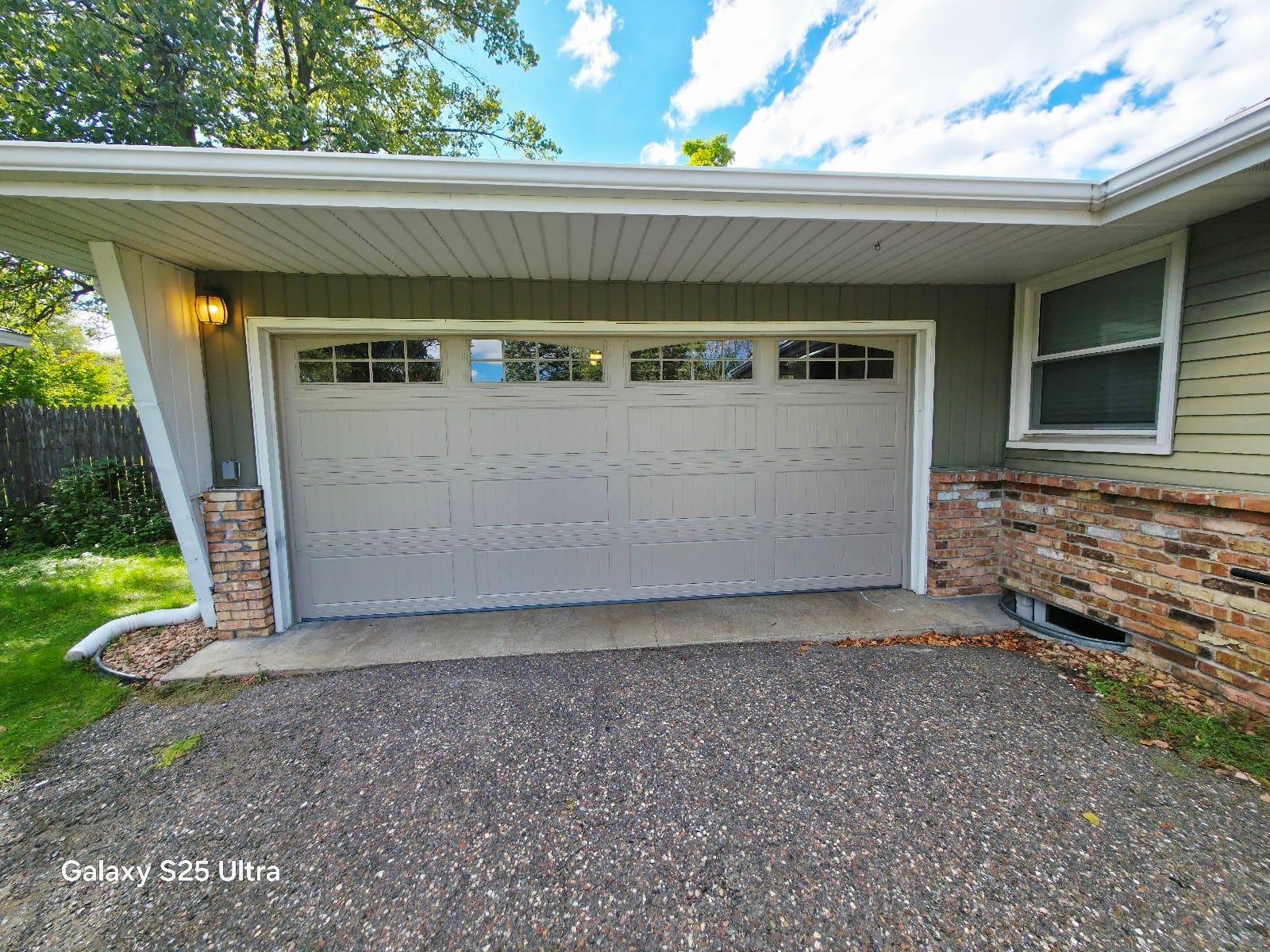 New DoorLink garage door with a window top section after replacing an old dented raised-panel door, Twin Cities MN