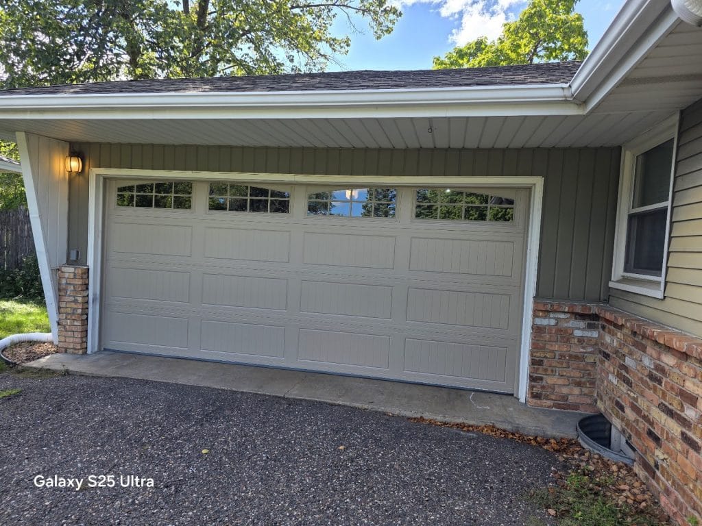 Finished new white garage door with window top section, driveway view, Minnesota