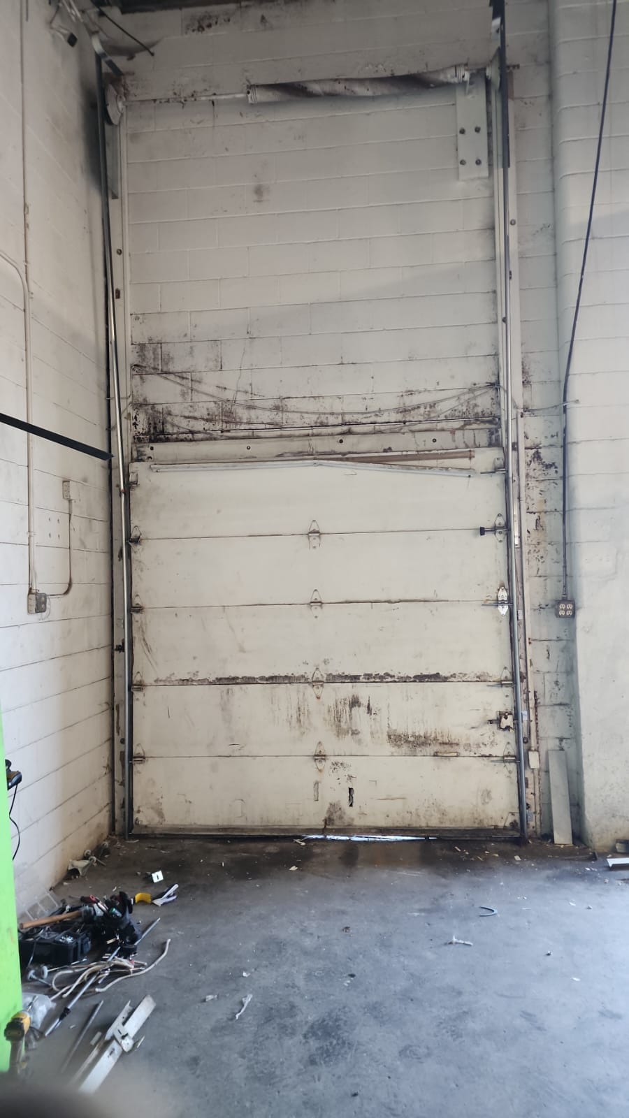 Rusted garage door hinges and track after Minnesota winters