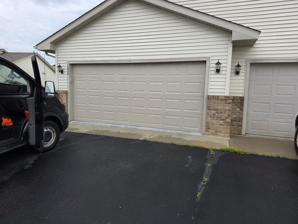 New white double garage doors at dusk, exterior view