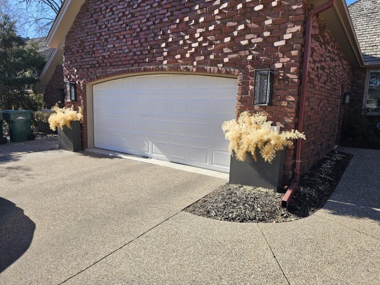 New white garage door under a brick arch, exterior view, serving Shoreview, MN