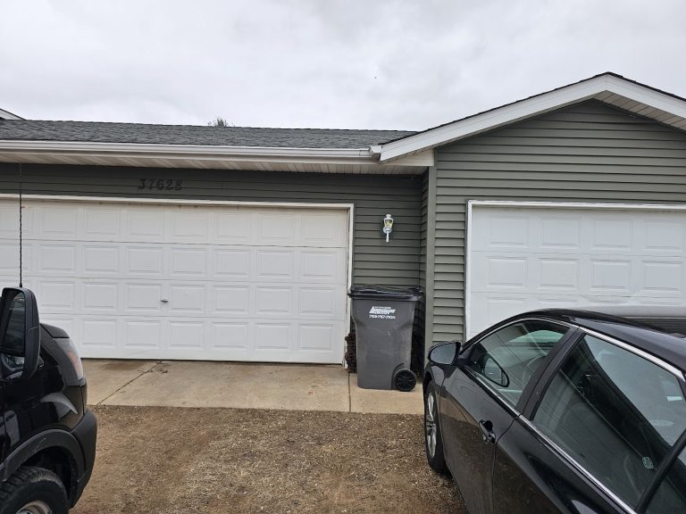New white garage door on an attached garage, grey house, serving Vadnais Heights, MN