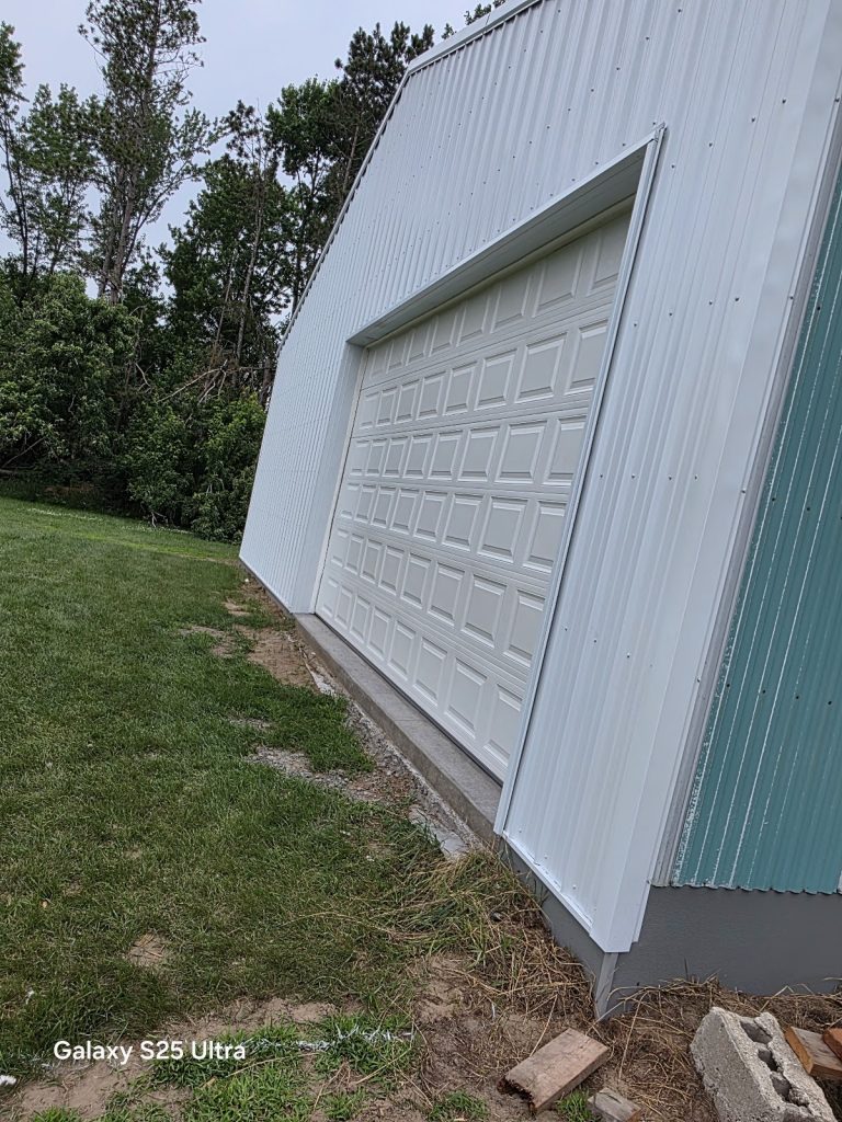 New white garage door on a metal building, side view, serving Mendota Heights, MN