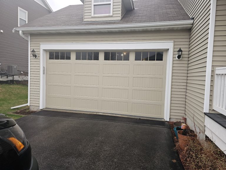 New white garage door with windows on a two-story home, serving Woodbury, MN