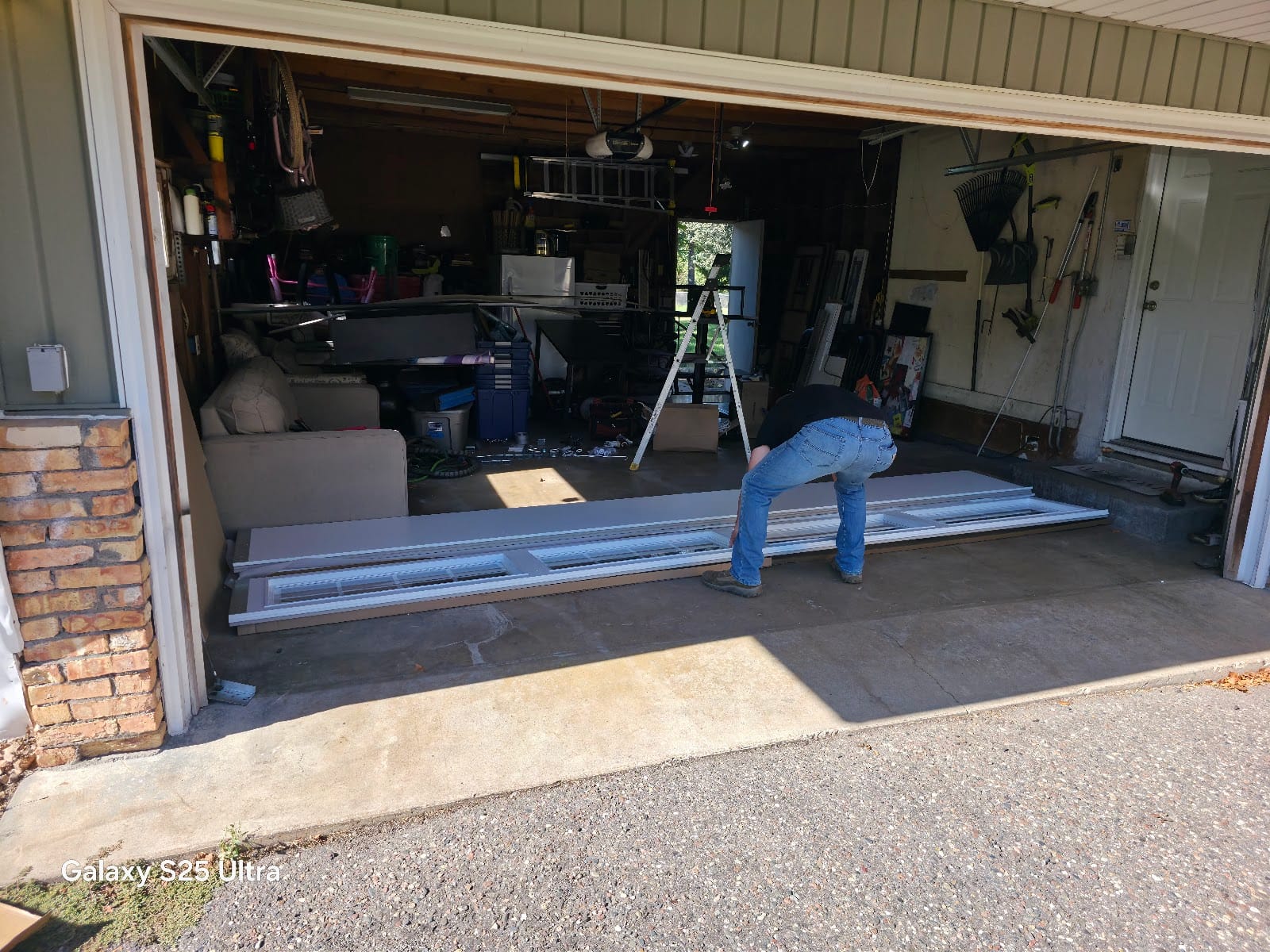 David assembling new garage door panels inside a customer's garage before installation, Minnesota