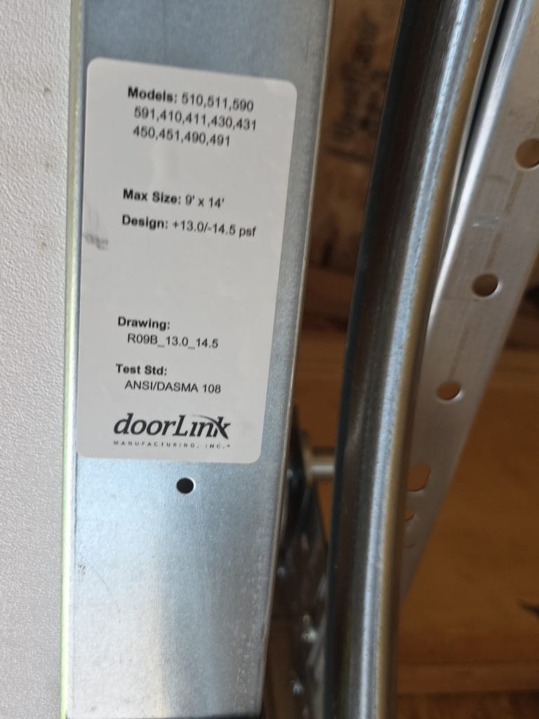DoorLink garage door wind-load label with model numbers, maximum size and design pressure rating