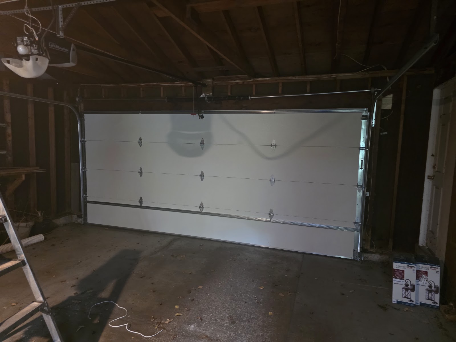 Inside view of a new double garage door with a strut on the top section, detached garage