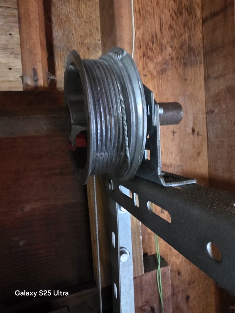 Garage door cable drum and torsion shaft close-up