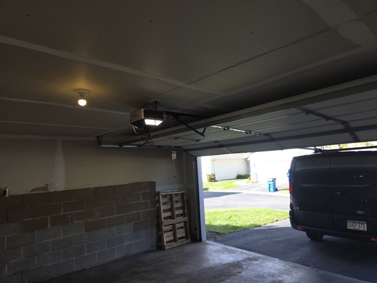 Garage door opener and rail installed, interior view with the door open, Minnesota