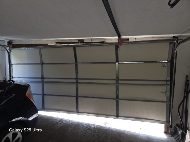 New garage door sections installed, seen from inside the garage