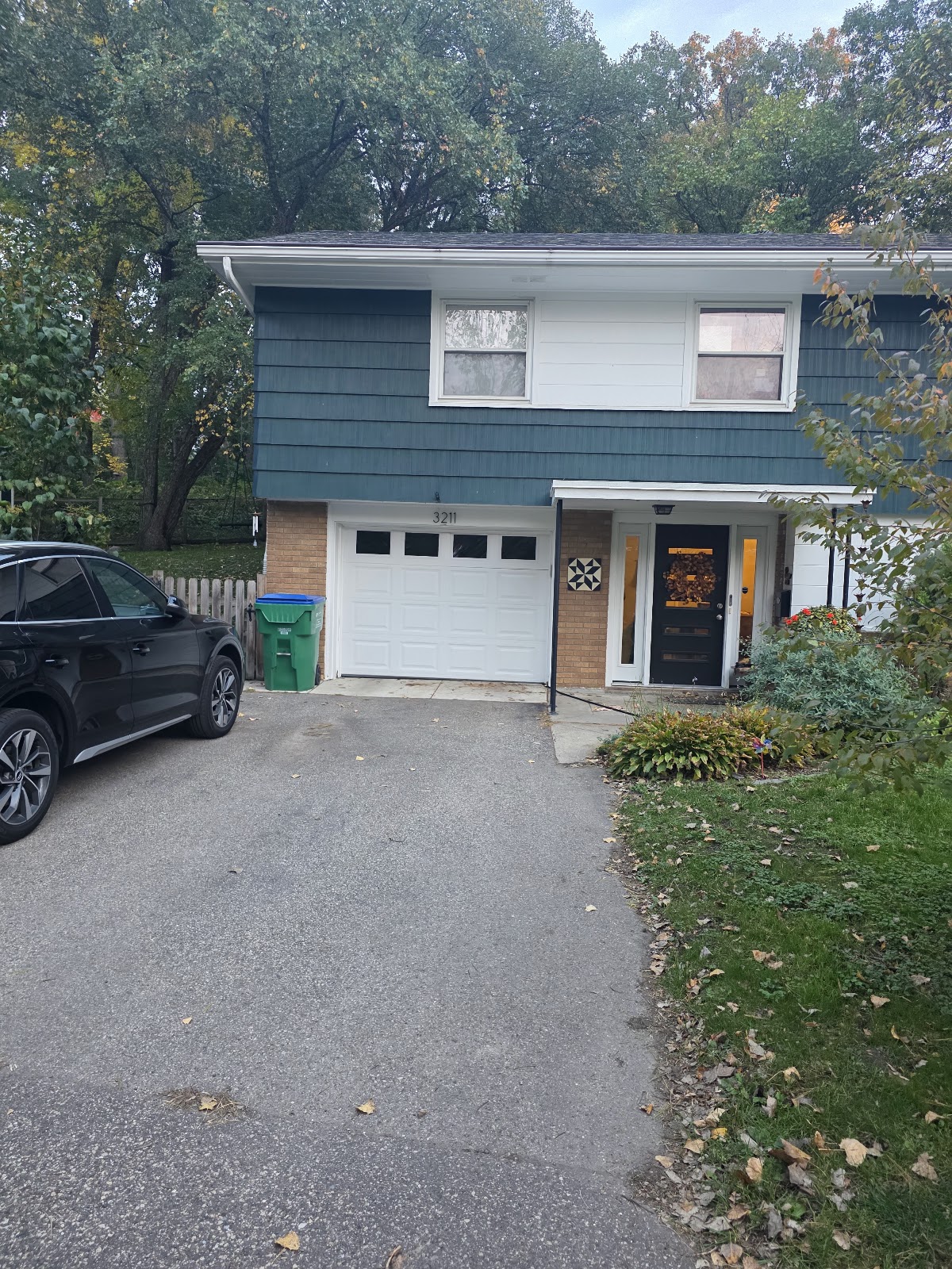 New white garage door with windows on a split-level home, west metro