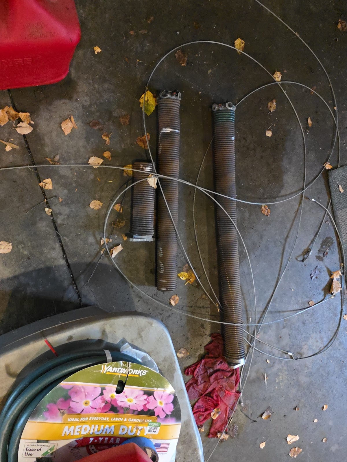 Old torsion springs and frayed lift cables removed during a spring and cable replacement